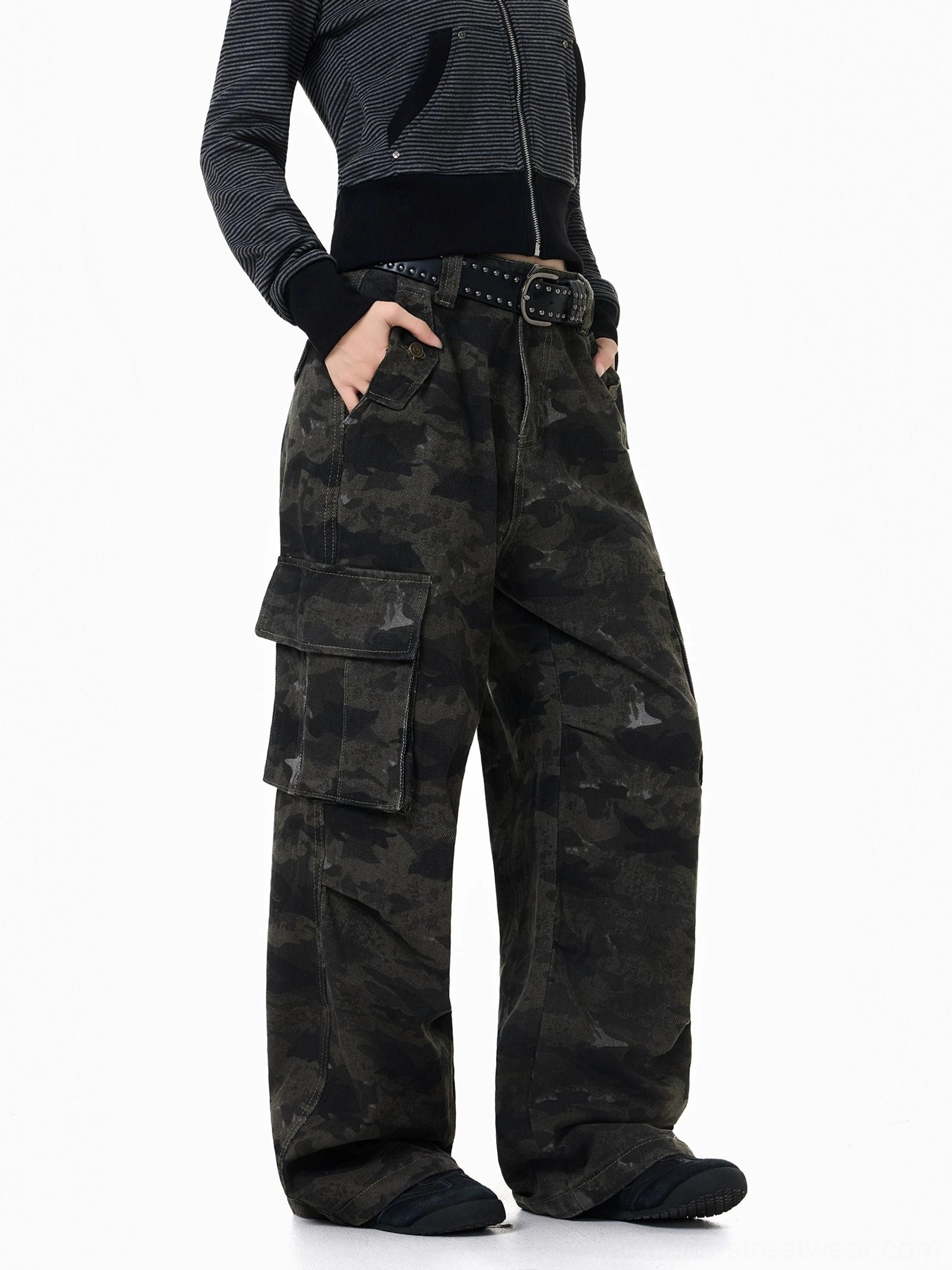 Left side view of dark camouflage streetwear cargo pants highlighting the oversized flap pocket, contrast stitching, and relaxed wide leg