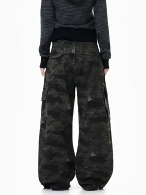 Rear view of dark washed camouflage wide-leg cargo pants showing loose baggy fit, back patch pockets, and streetwear silhouette