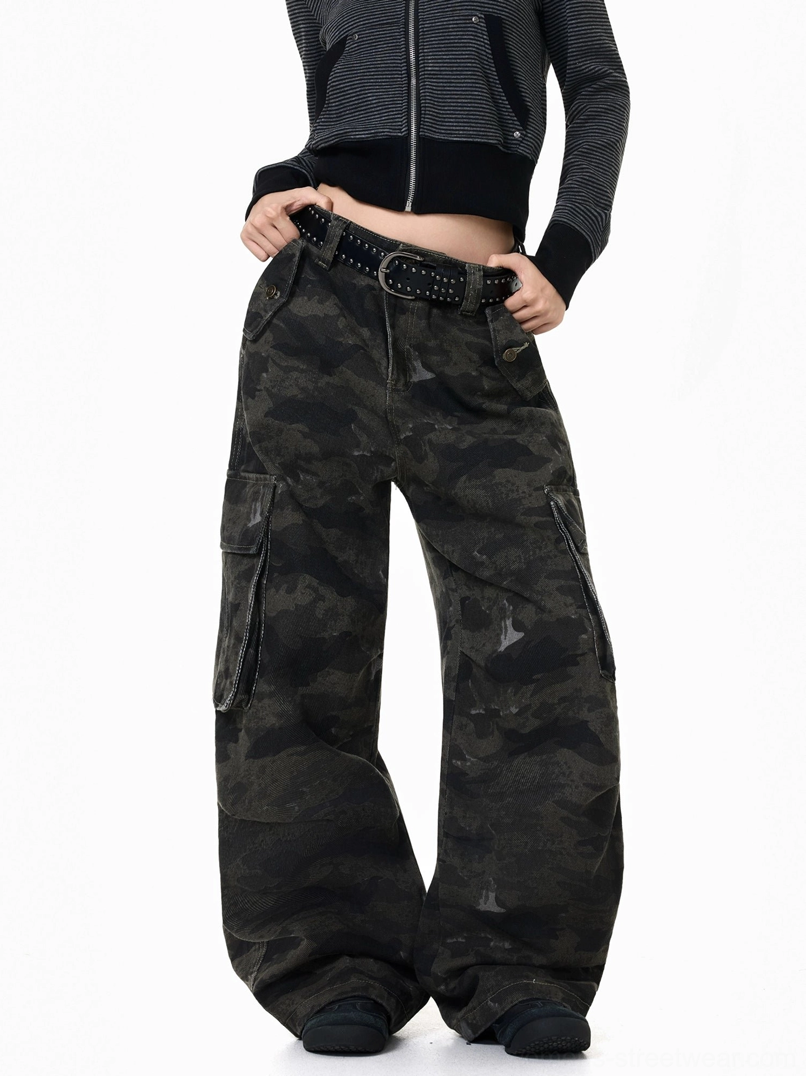 Front right view of Y2K dark camouflage cargo pants with wide legs, flap utility pockets, faded camo texture, and stacked hems