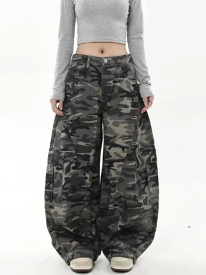 Front view of oversized camouflage cargo jeans featuring button fly closure, relaxed mid-rise waist, and dramatic wide-leg streetwear fit