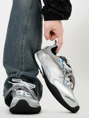 Silver blue Shadow Stream retro athletic sneakers displayed with baggy blue denim, featuring breathable mesh panels, silver white synthetic overlays, blue accents, and dual-tone flat laces