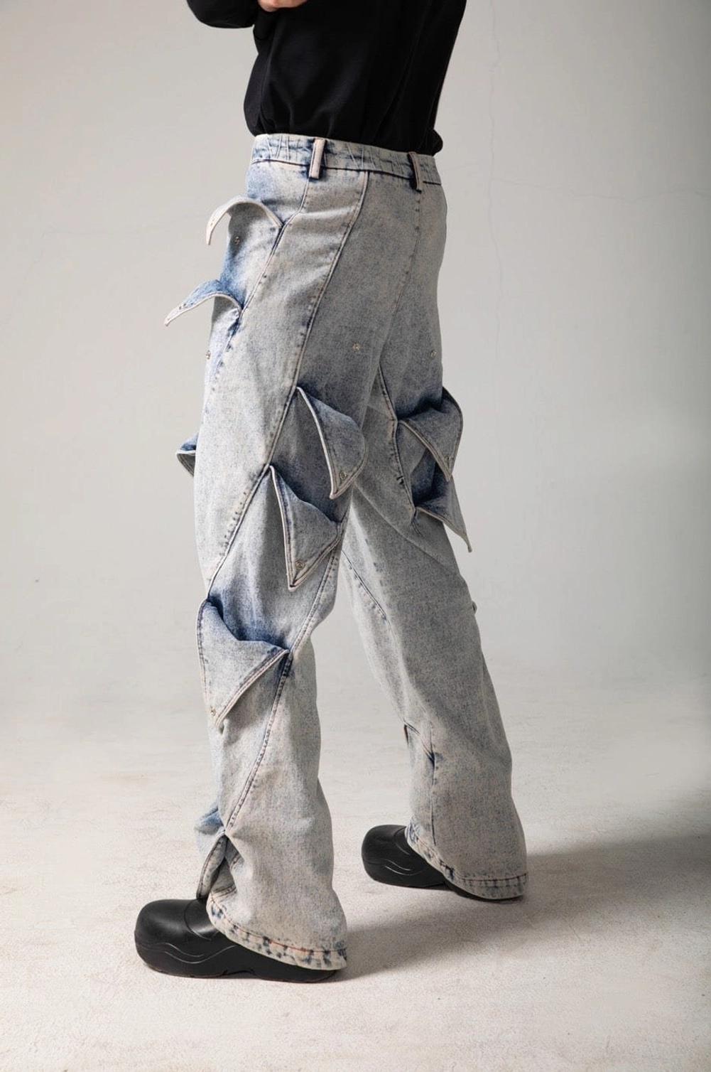 Shark fin panel acid wash baggy jeans styled as contemporary Y2K wide leg streetwear denim