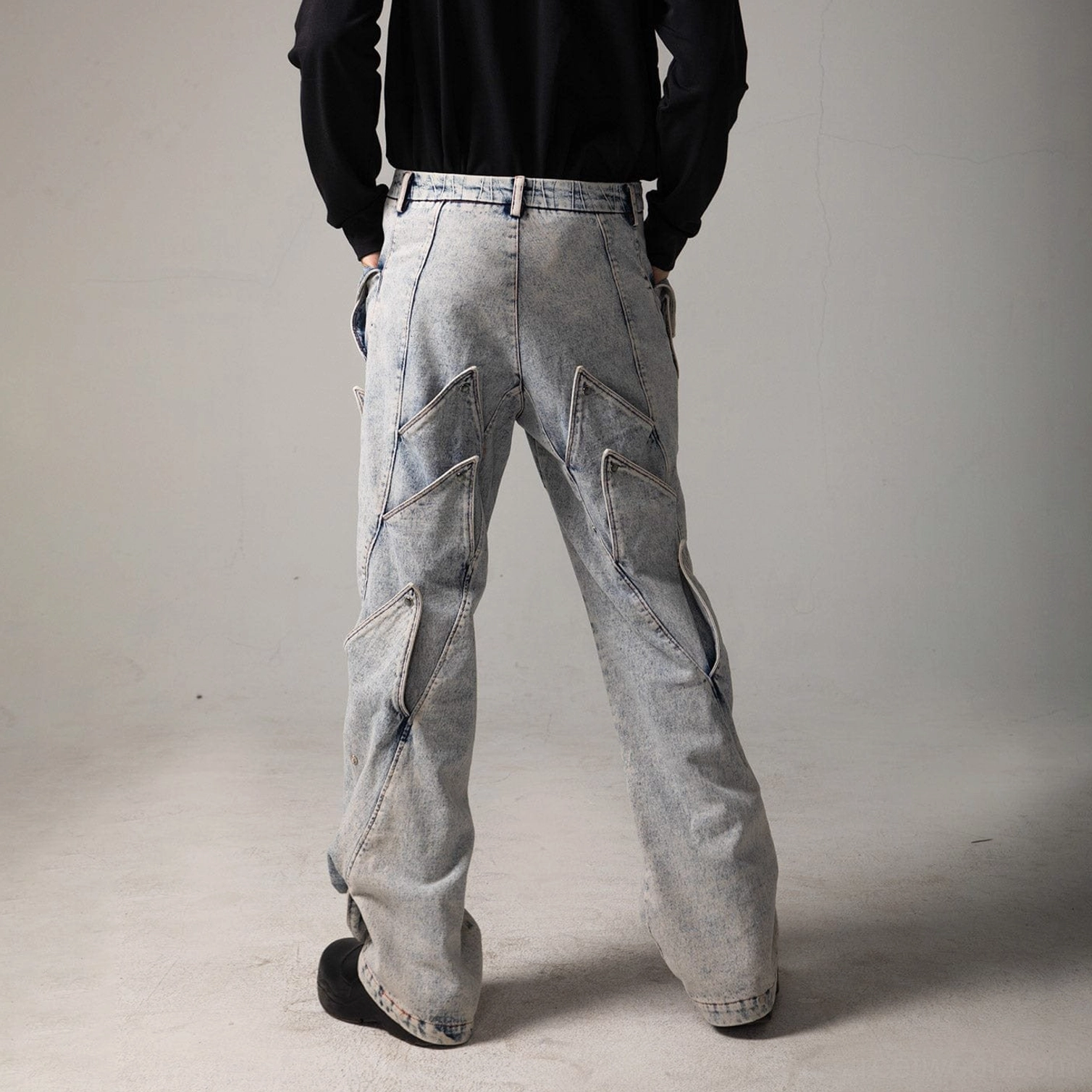 Back view of shark fin panel baggy jeans showing faded denim, rear panel details, and relaxed wide leg silhouette