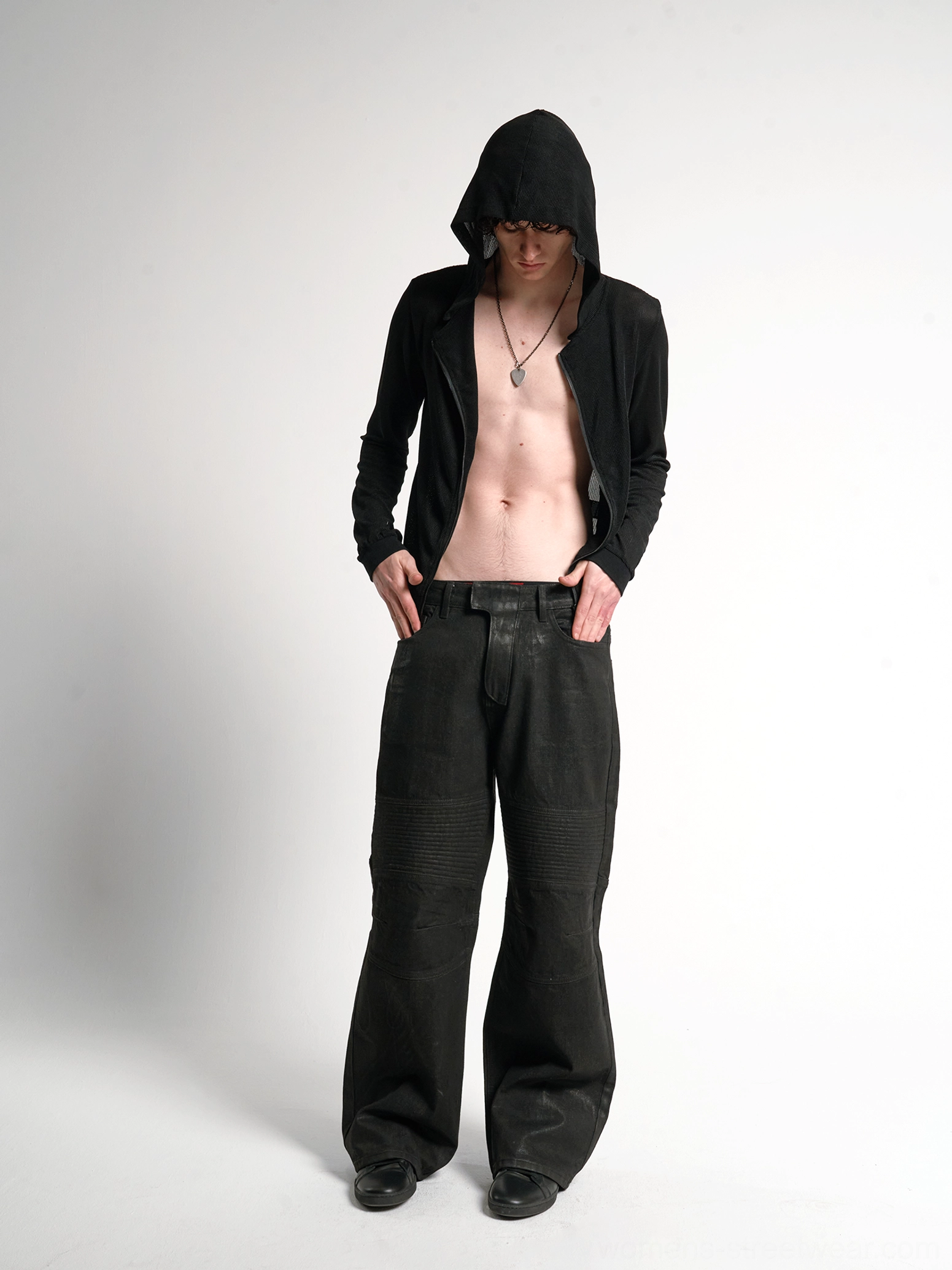 Sheer black cross script zip-up hoodie worn open by male model with matching streetwear track pants front view