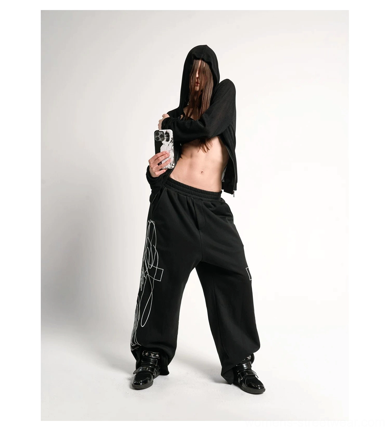 Black cropped sheer zip-up hoodie and matching graphic track pants styled as a Y2K streetwear outfit