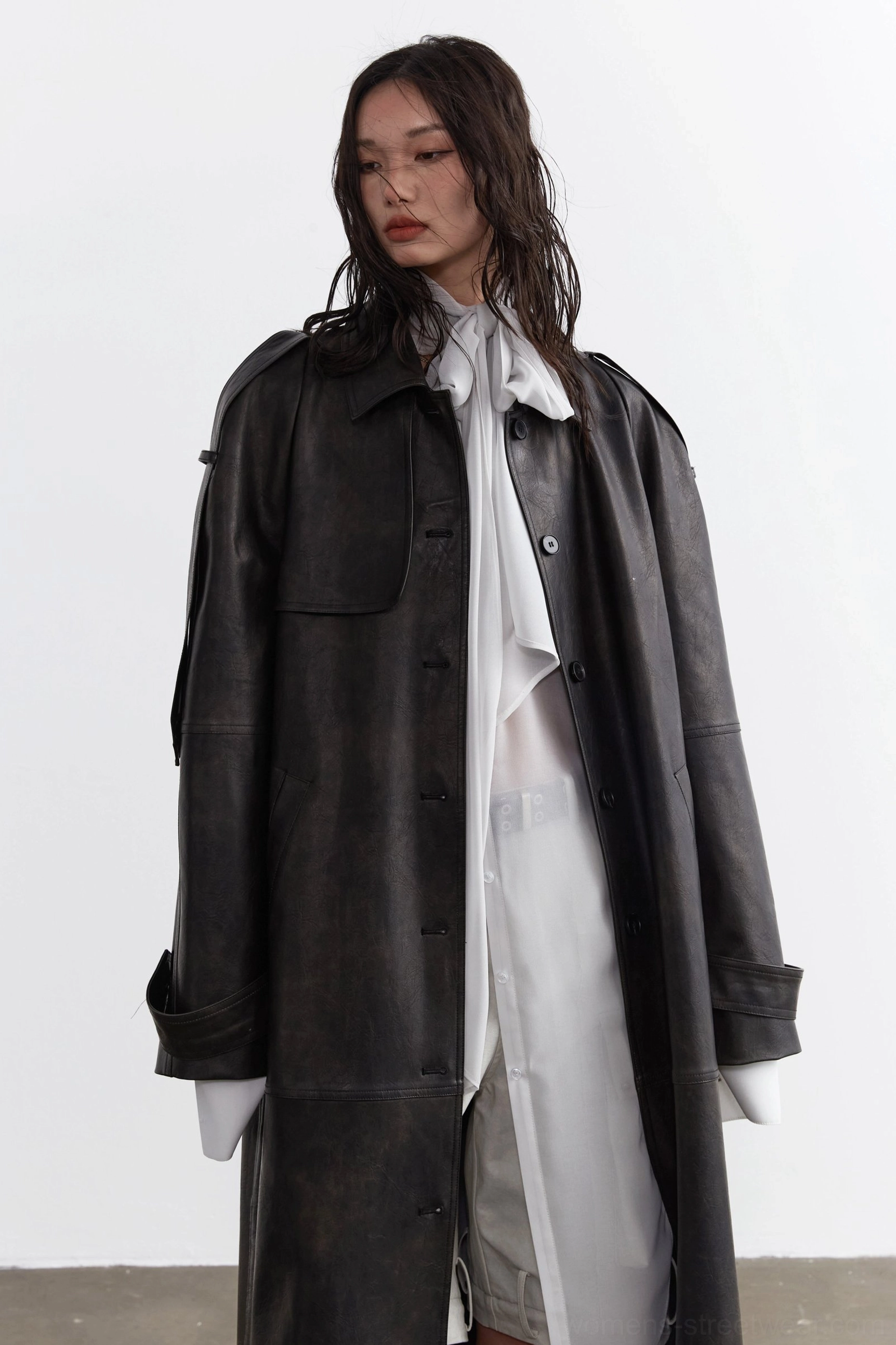 Front view of a sheer chiffon neck-tie blouse with large attached bow and oversized loose fit