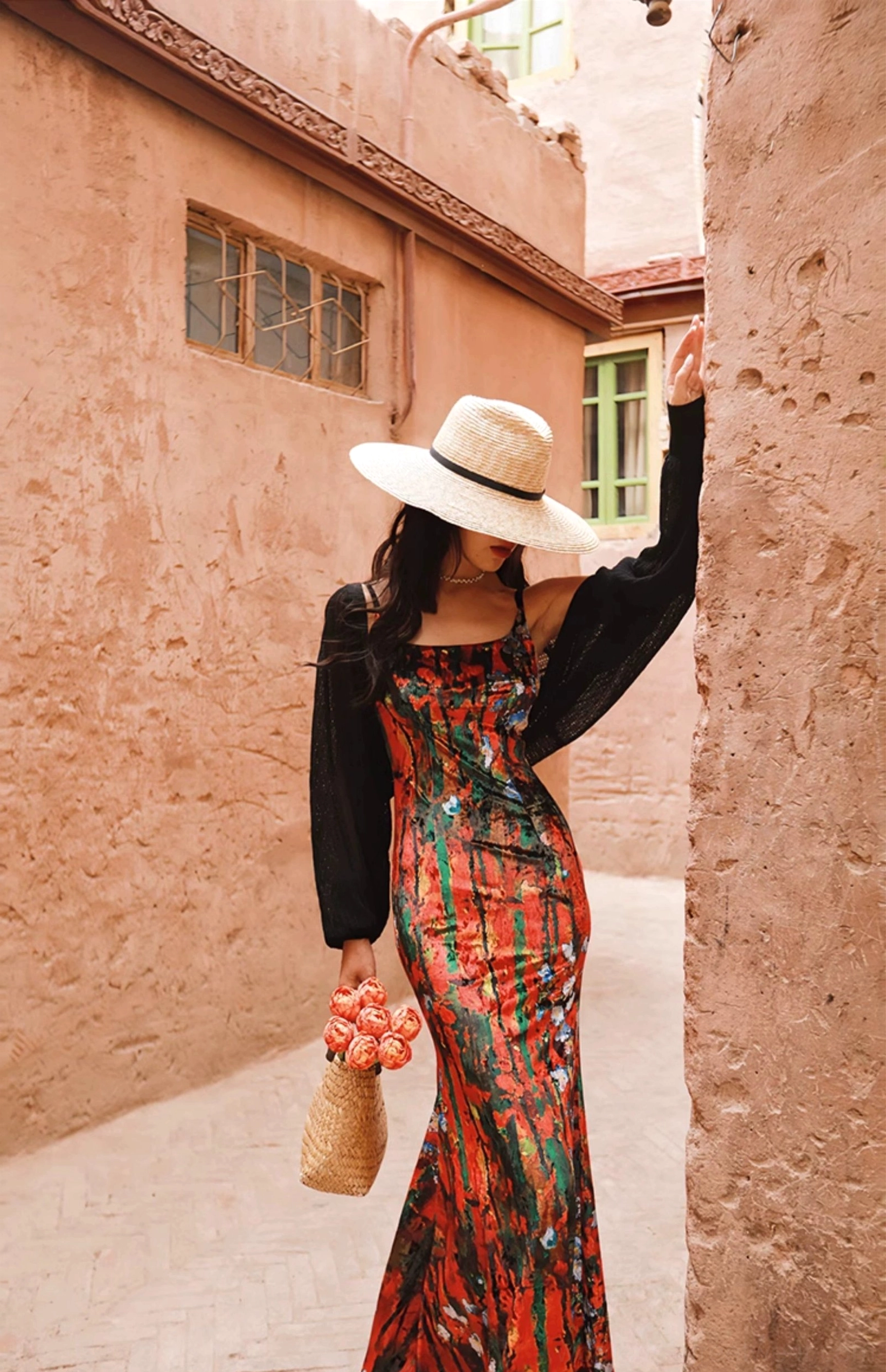 Black sheer puff sleeve knit shrug cardigan styled over a tropical floral maxi dress