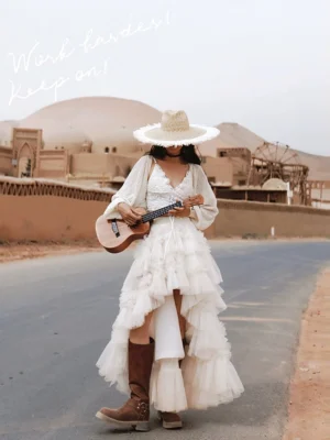 Desert editorial fashion look with tiered tulle dress and wide brim straw hat