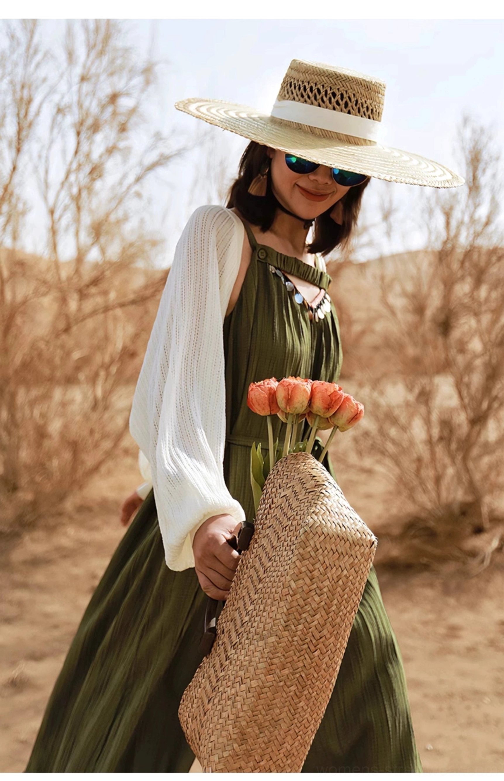 Green sheer knit batwing shrug cardigan layered over a two-tone maxi dress in desert scenery