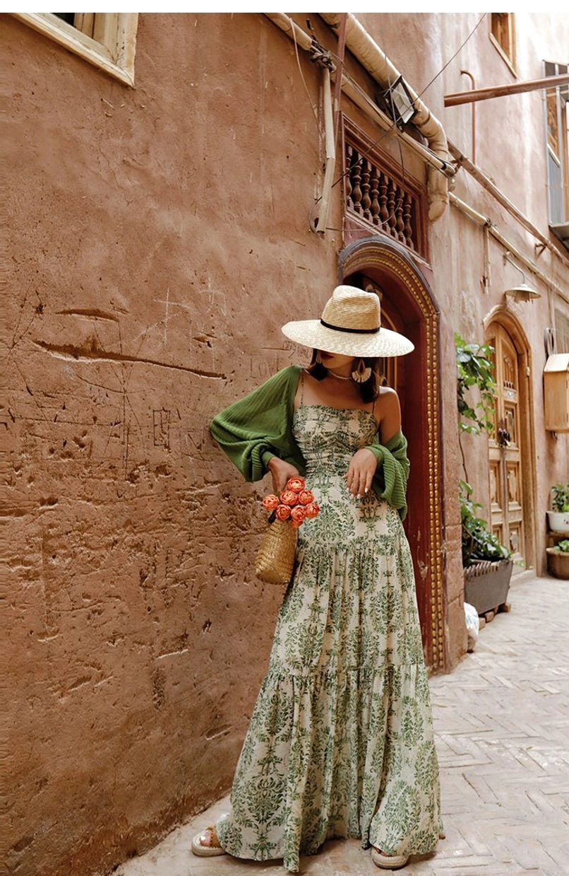 Side view of green cropped sheer knit shrug cardigan over a floral print maxi dress