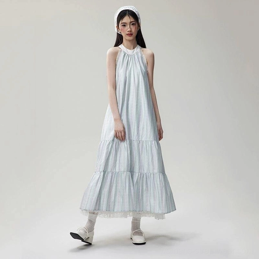 Full side view of a sheer lace hem gingham halter maxi dress with loose tiered skirt, matching headband, Mary Jane shoes, and frilled socks