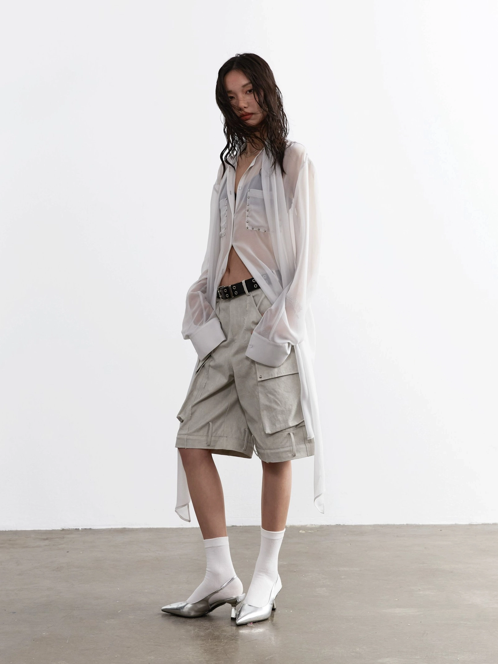Sheer white long-sleeve blouse with partial button front and layered innerwear styling
