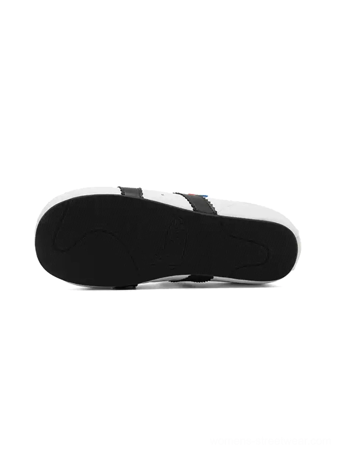Black rubber outsole and white midsole detail of shell toe strap sneakers with hidden lift
