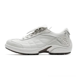 White low-top streetwear sneaker with oversized lace flap, smooth layered upper, brown midsole accent, and industrial-inspired metal details