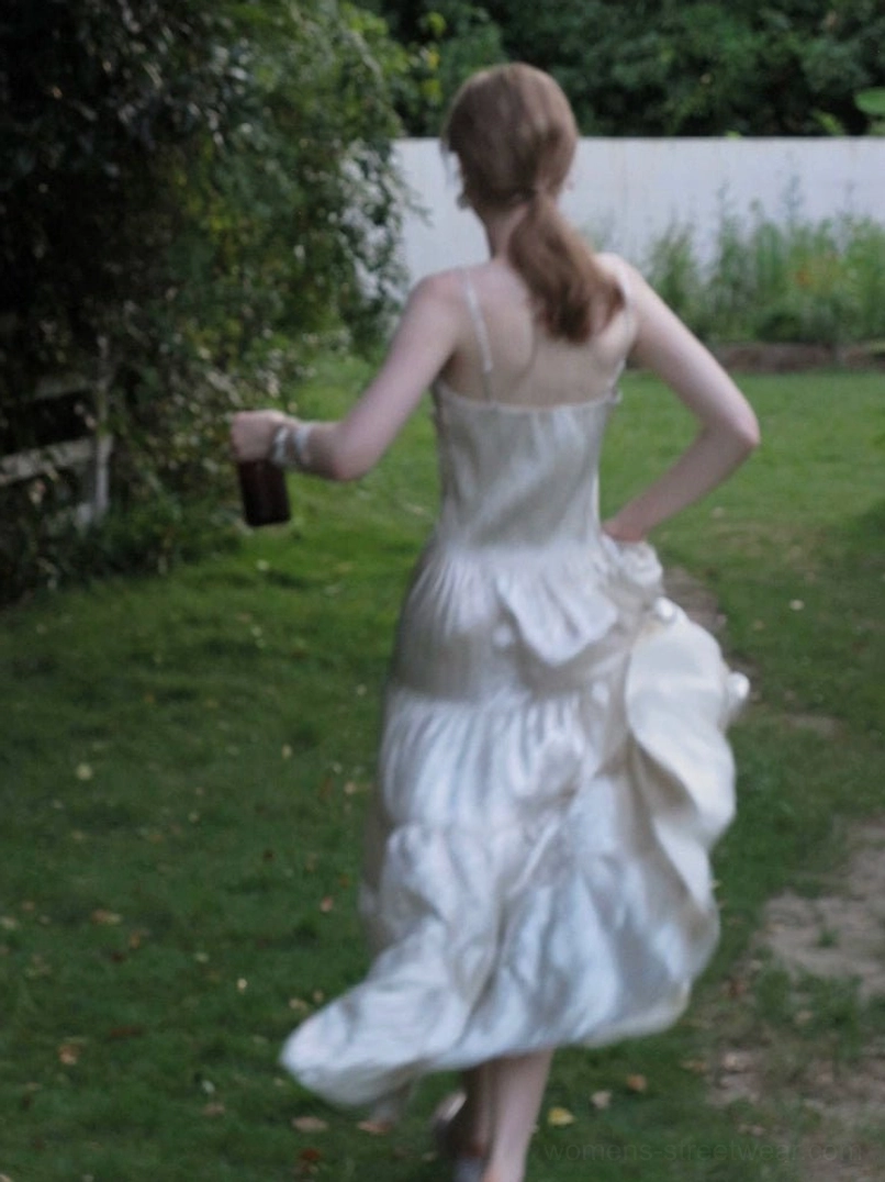 Backless champagne ruffled tiered maxi dress showing low open back and flowing layered skirt