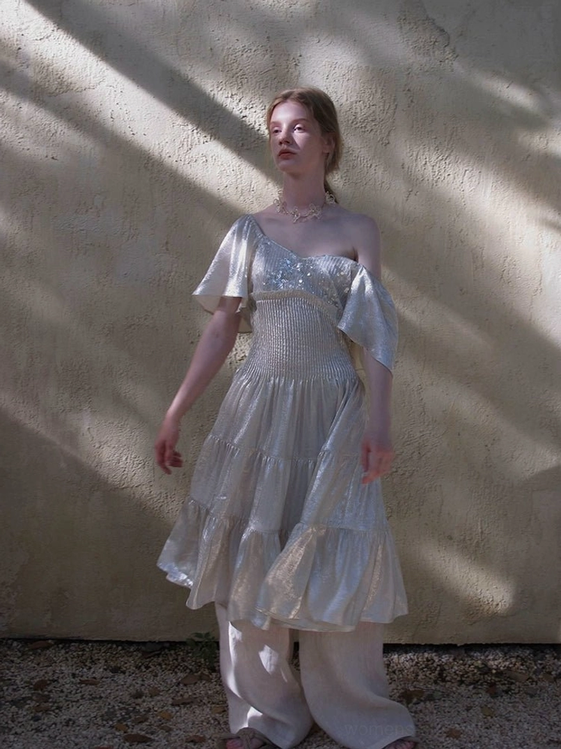 Champagne off shoulder ruffle sleeve tiered dress with glossy fabric and gathered waist in outdoor styling