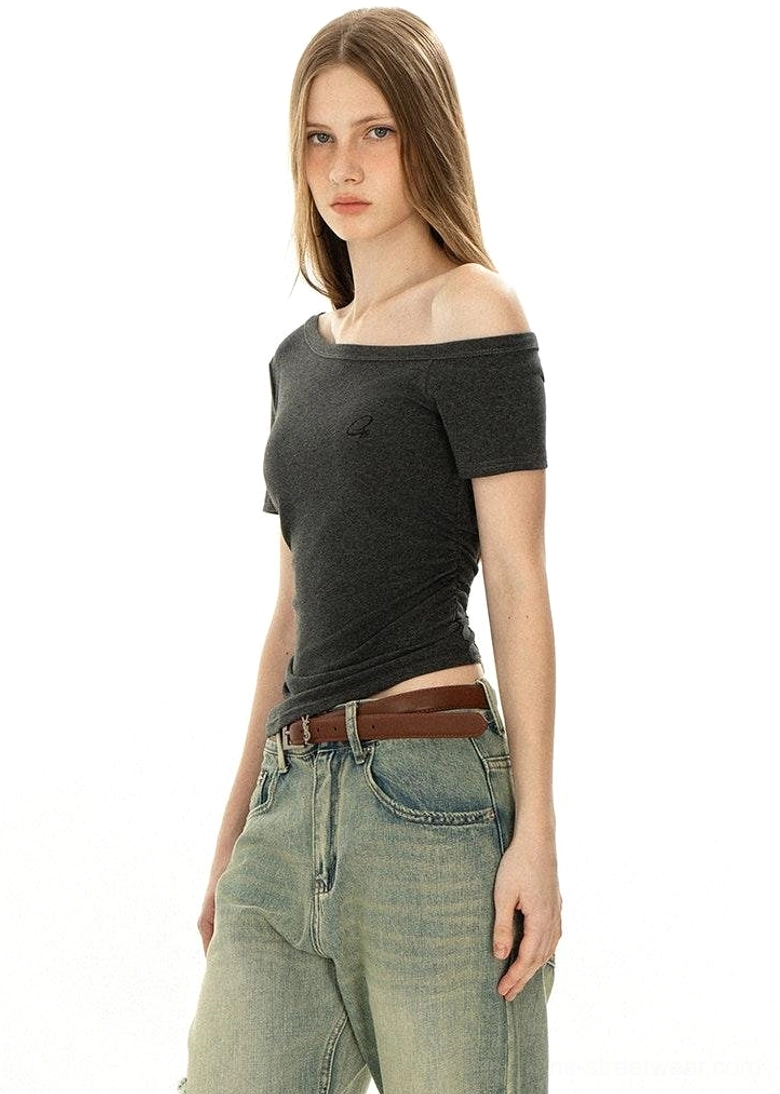 Side profile off-shoulder dark grey minimalist tee boat neckline short sleeves vintage aesthetic with ripped jeans and brown belt