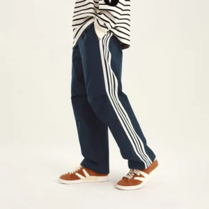 Blue side-stripe streetwear cargo pants with relaxed utility fit, contrasting white side stripes, and pleated knees