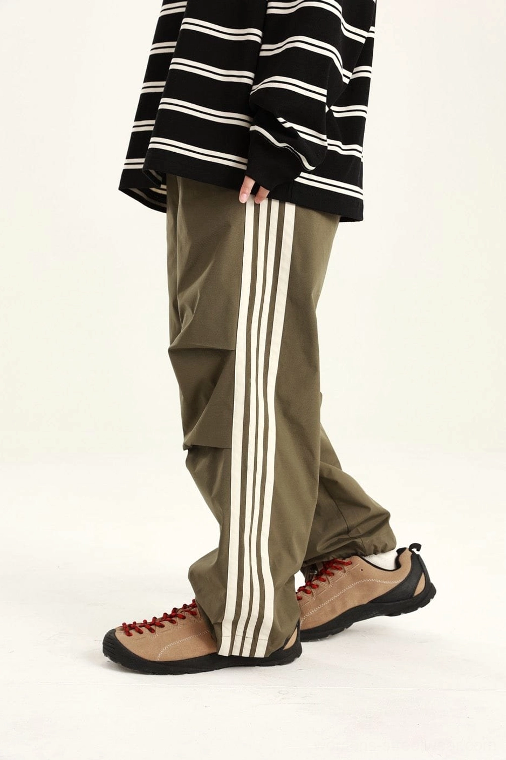 Modern side-stripe streetwear pants featuring an easy athletic-inspired fit and urban utility styling