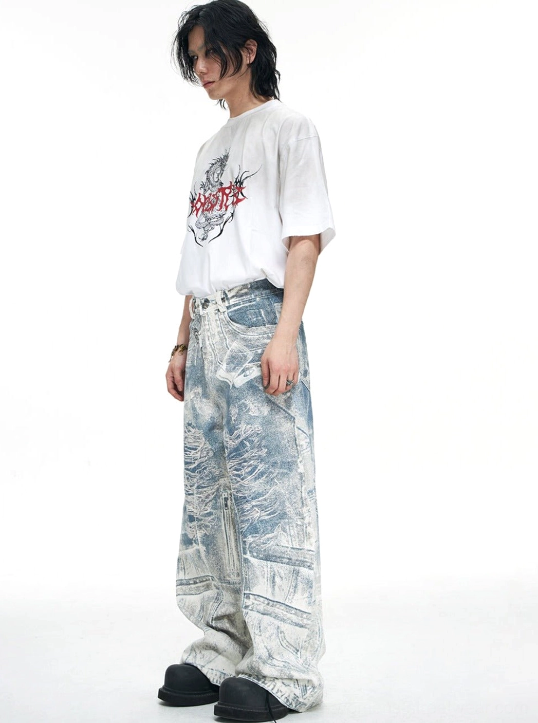 Side view of blue acid-wash distressed wide-leg jeans showing the relaxed oversized cut and streamlined streetwear silhouette