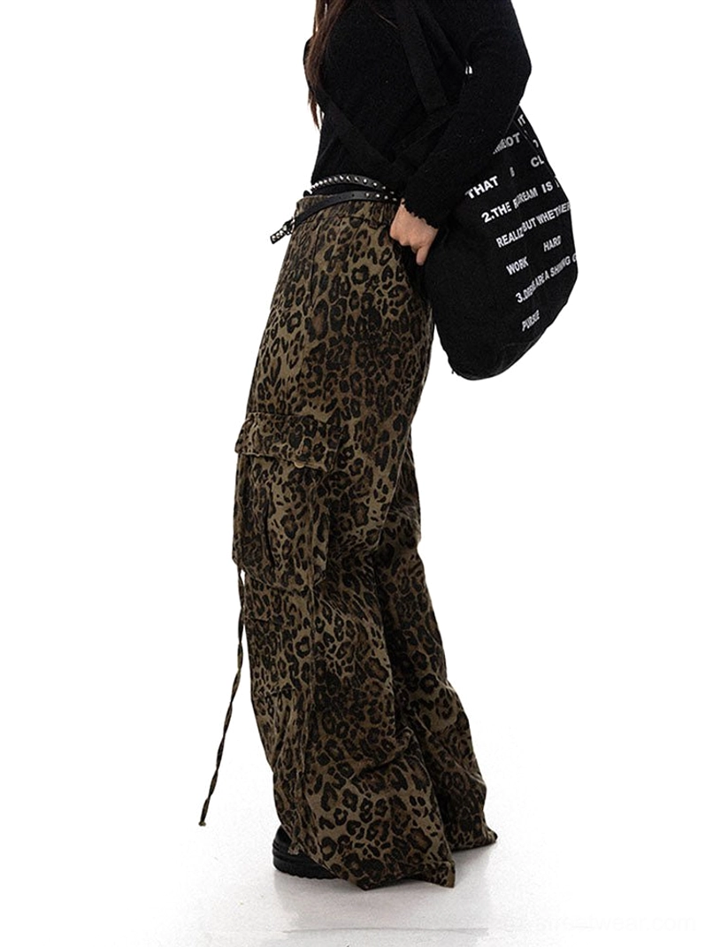 Side view of brown leopard wide leg cargo pants with utility pockets and hanging drawstrings styled with a black canvas tote bag