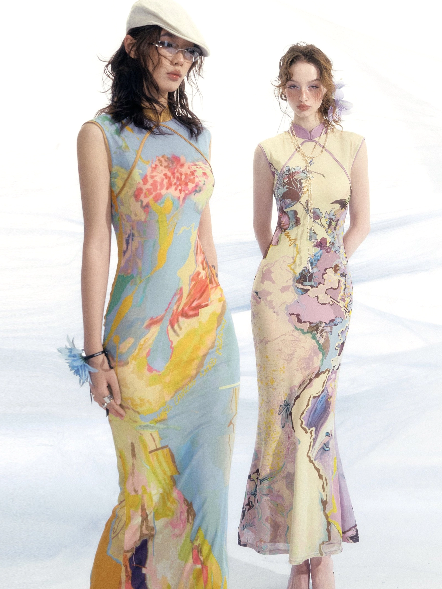Side view of sleeveless floor length watercolor mesh cheongsam dresses with fitted fishtail hems and abstract floral prints