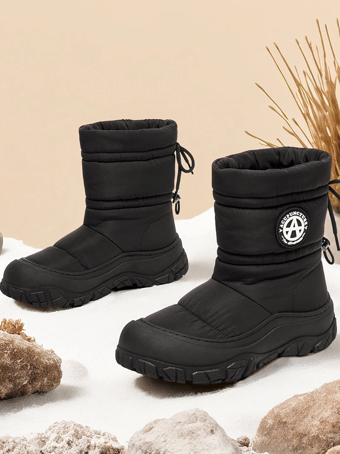 Silver drawstring puffer snow boots product photo highlighting the quilted padded upper and mid-calf profile