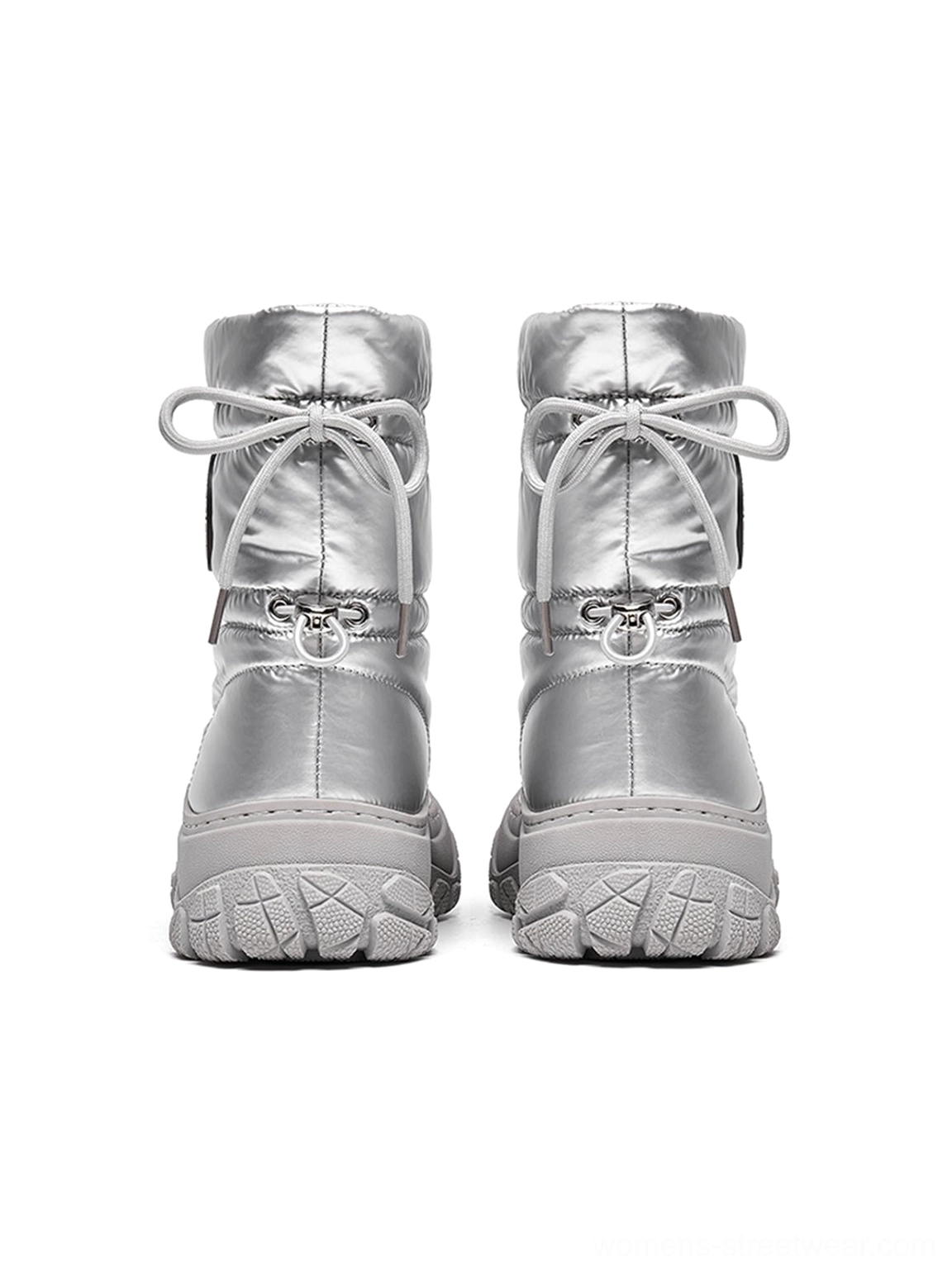 Rear view of paired silver drawstring puffer snow boots with adjustable back closures, textured treaded soles, and shaft badge details