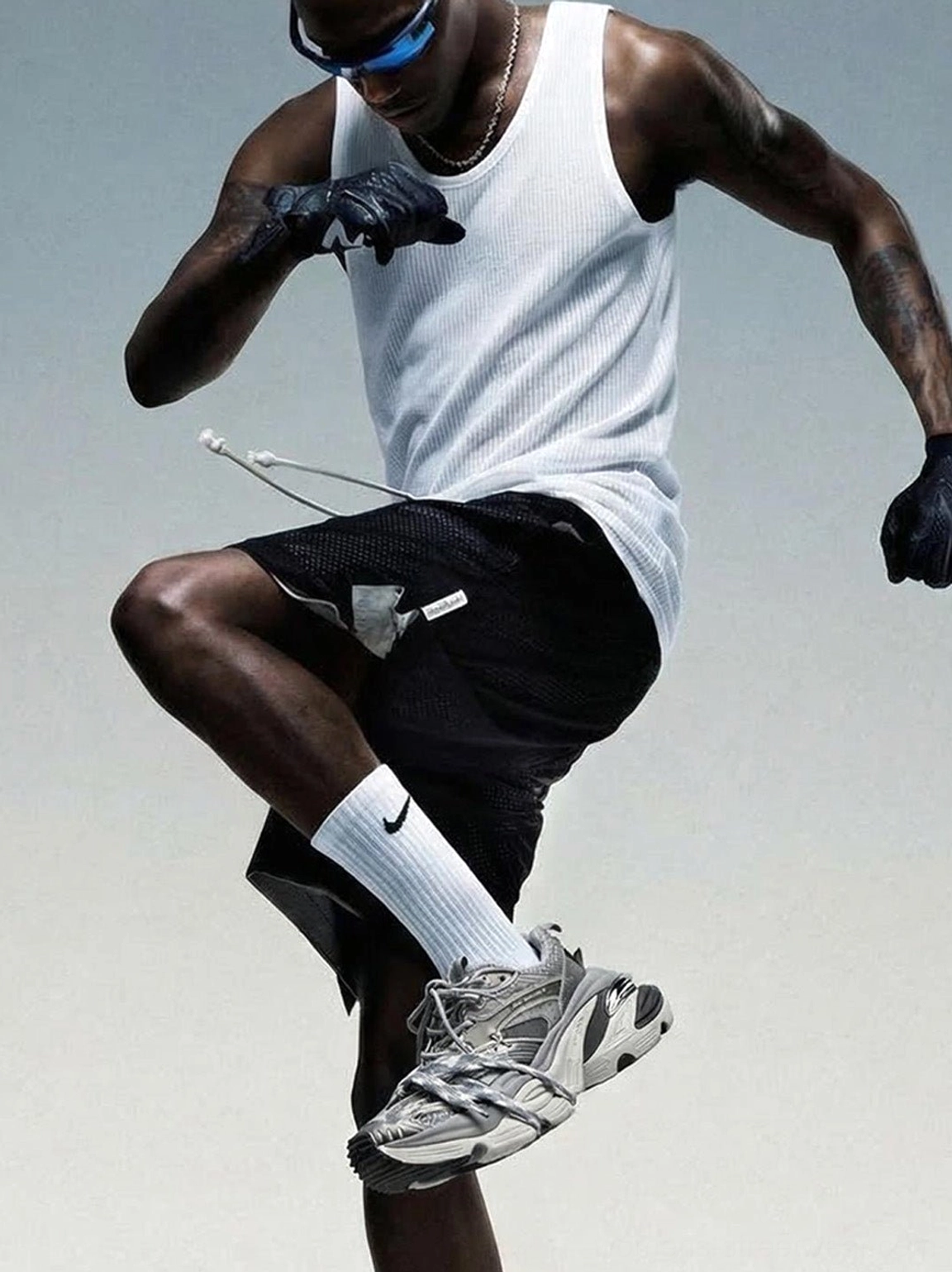 Silver gray chunky platform sneakers styled on a male streetwear model in a dynamic low angle fashion shot