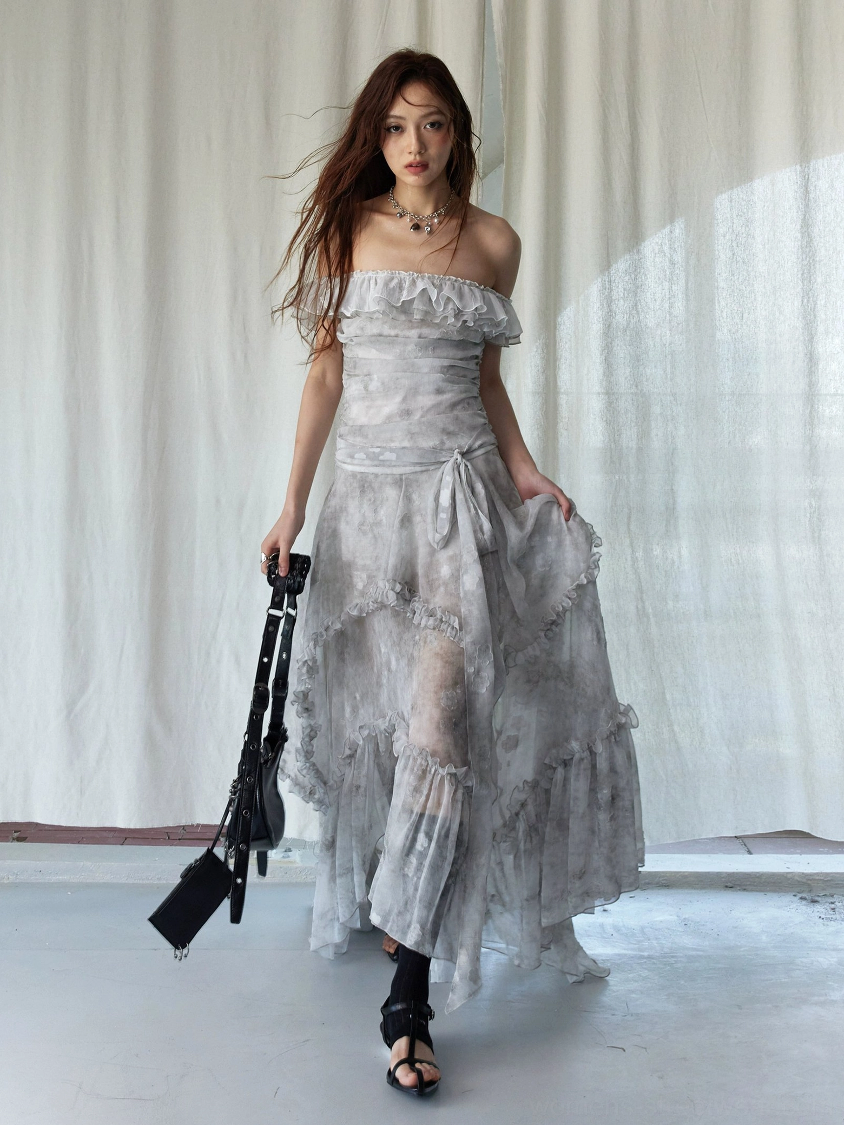 Front view of silver gray tie-dye ruffled maxi dress featuring ruched waist sash, layered skirt, and off-shoulder neckline