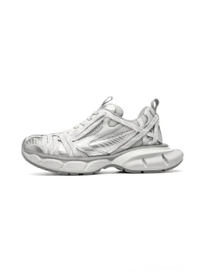 Silver gray layered mesh chunky runner sneakers shown in side profile with metallic overlays, woven upper panels, and a thick sculpted streetwear sole