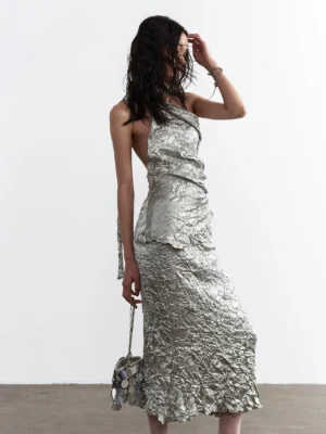 Silver metallic crinkle one shoulder maxi dress set shown from the rear with open back halter strap and fitted evening skirt