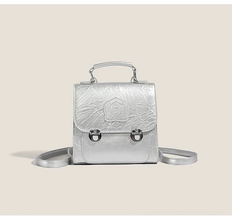 Silver metallic crinkle PU crested mini satchel crossbody bag with silver hardware, top handle, and detachable strap