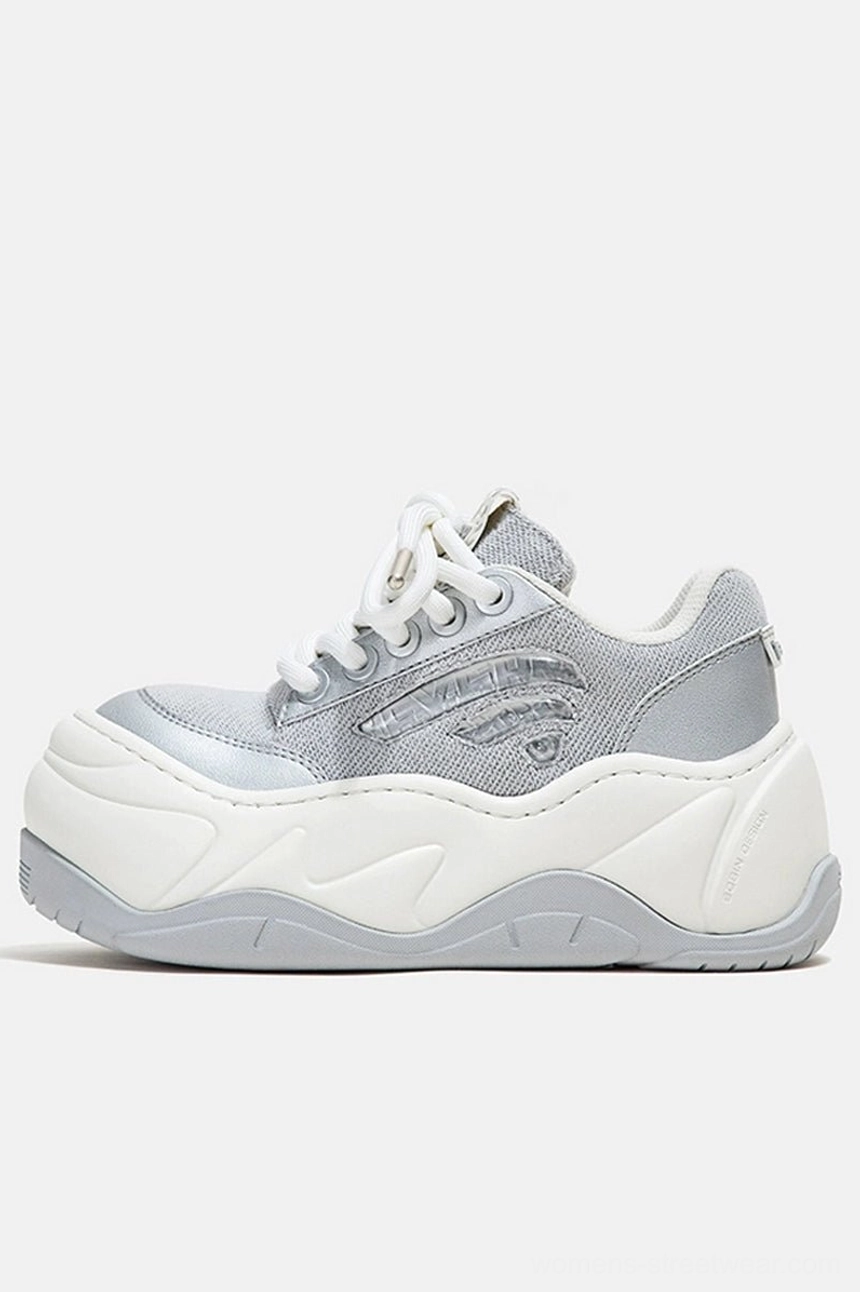 Silver metallic mesh wave platform chunky sneakers in side profile with layered white rubber sole