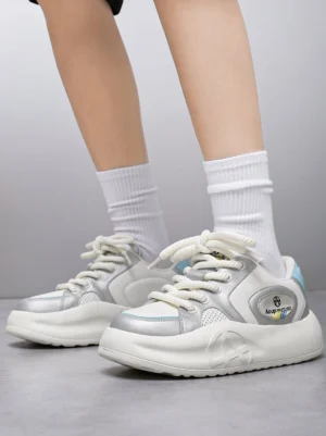 Silver metallic PU platform sneakers worn with white crew socks showing the chunky cushioned sole and elevated streetwear silhouette