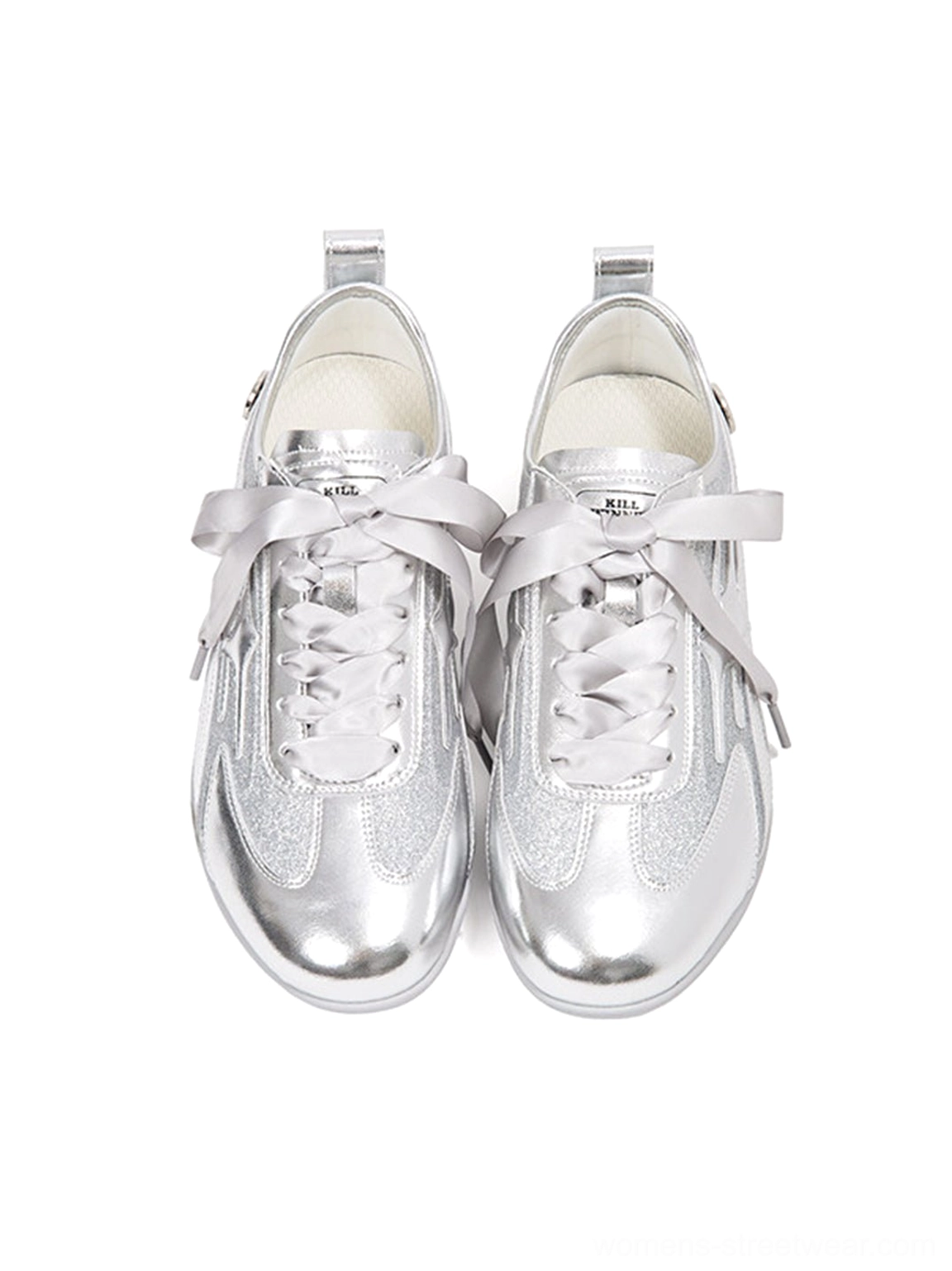 Low three-quarter view of sleek silver metallic streetwear trainers with sculpted overlays and streamlined athletic sole