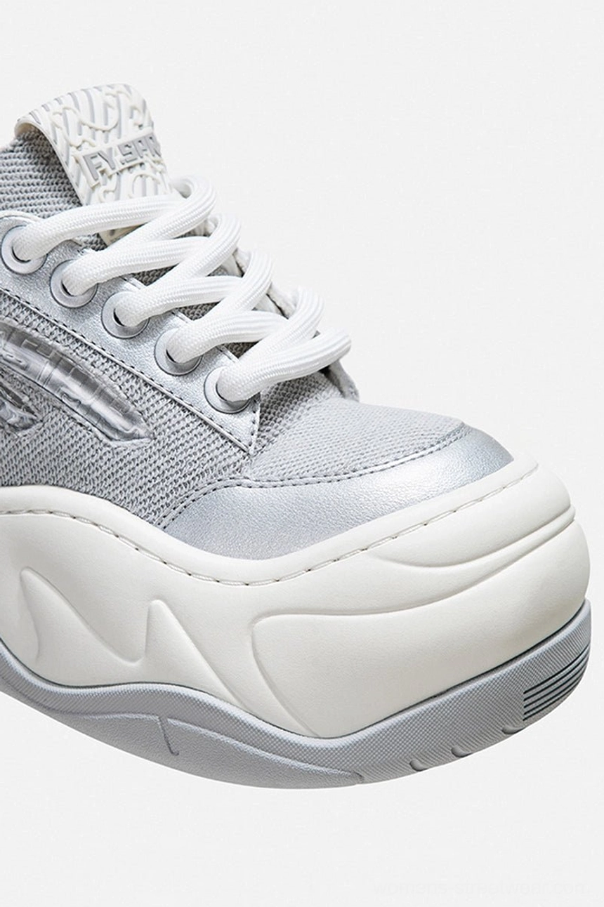 Close-up of silver metallic toe cap and wide laces on wave platform chunky sneaker