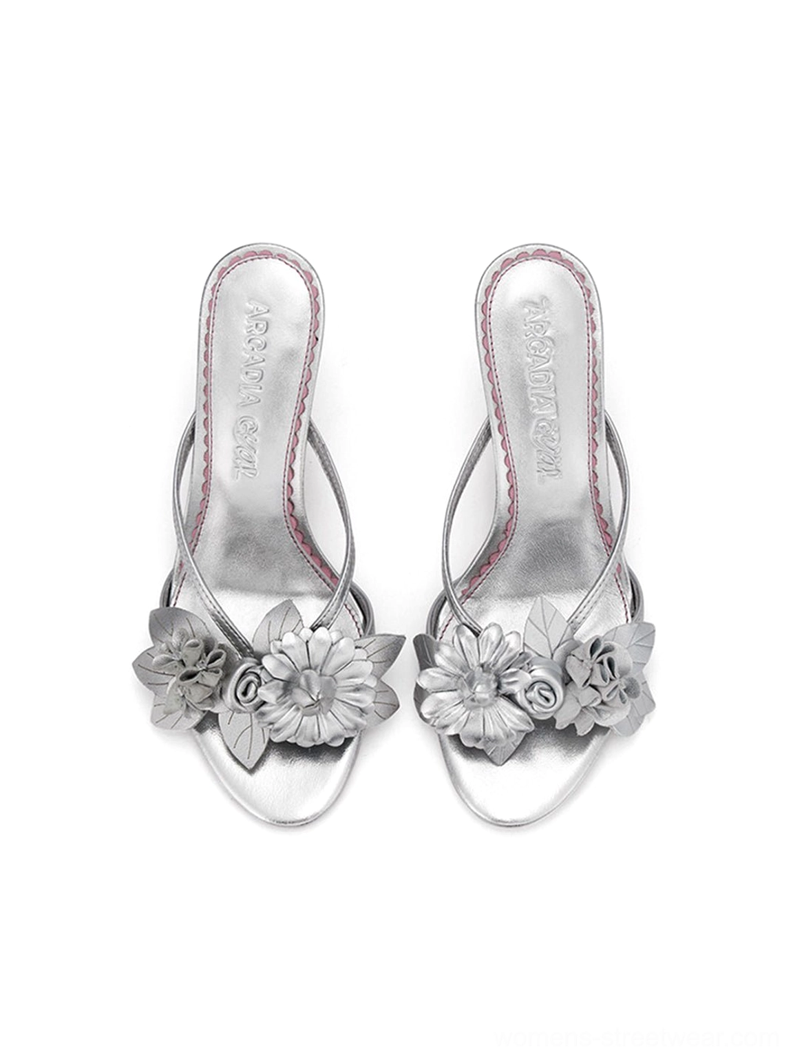 Silver open toe floral slide sandals with a refined kitten heel, crisscross vamp straps, and romantic dimensional flower embellishment