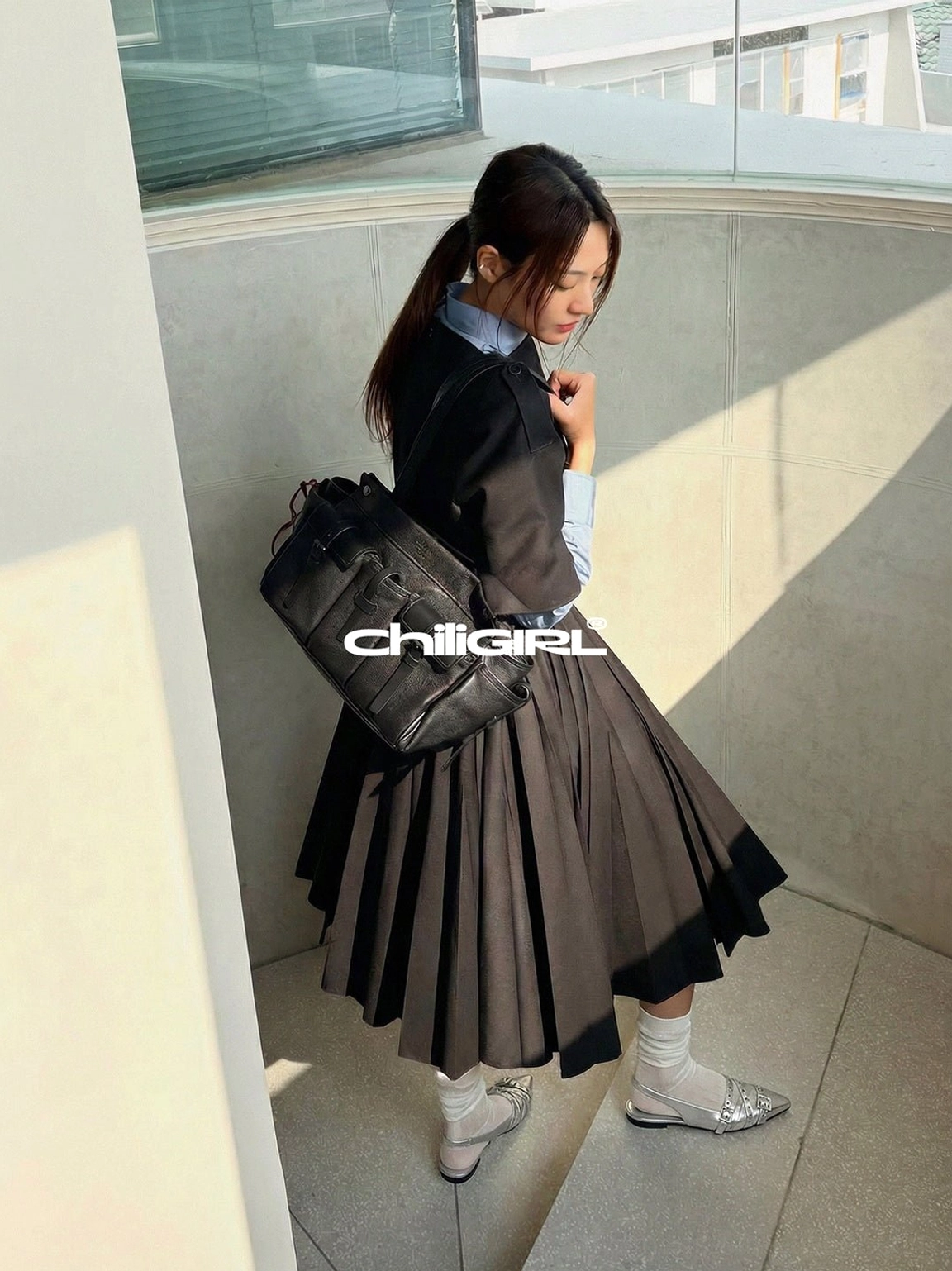 Silver pointed-toe slingback flats paired with sheer socks, a dark blazer, pleated midi skirt, and black crossbody bag