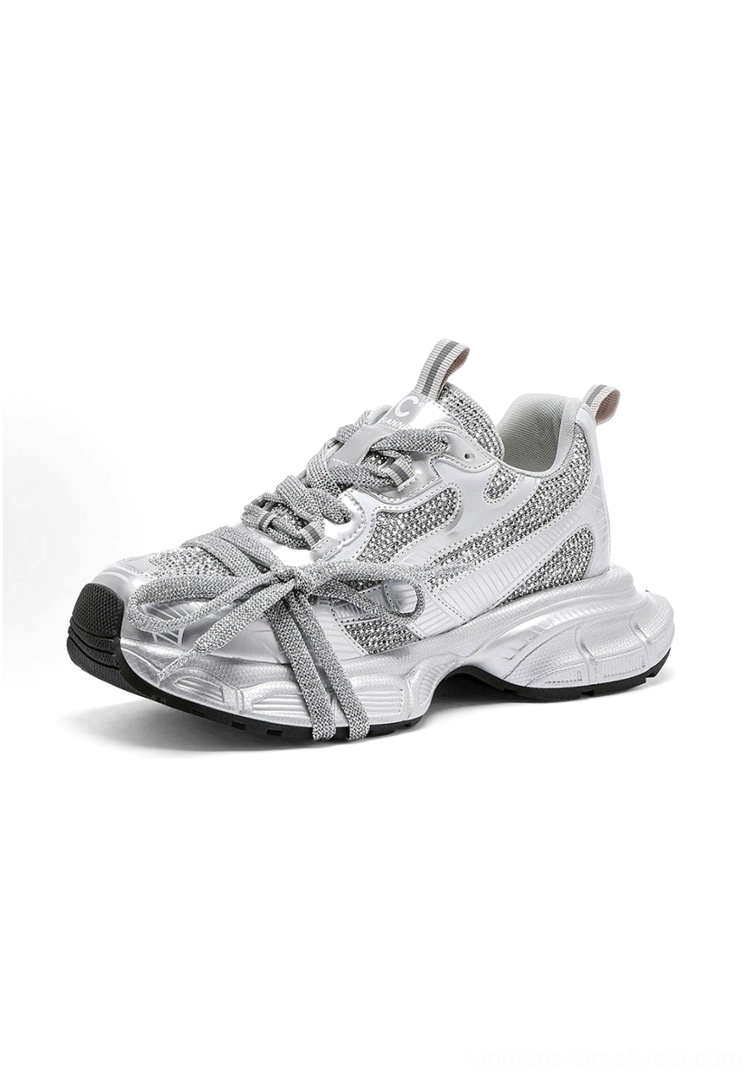 Front three-quarter view of rhinestone-encrusted silver chunky dad sneakers with decorative bow-shaped laces and raised sole