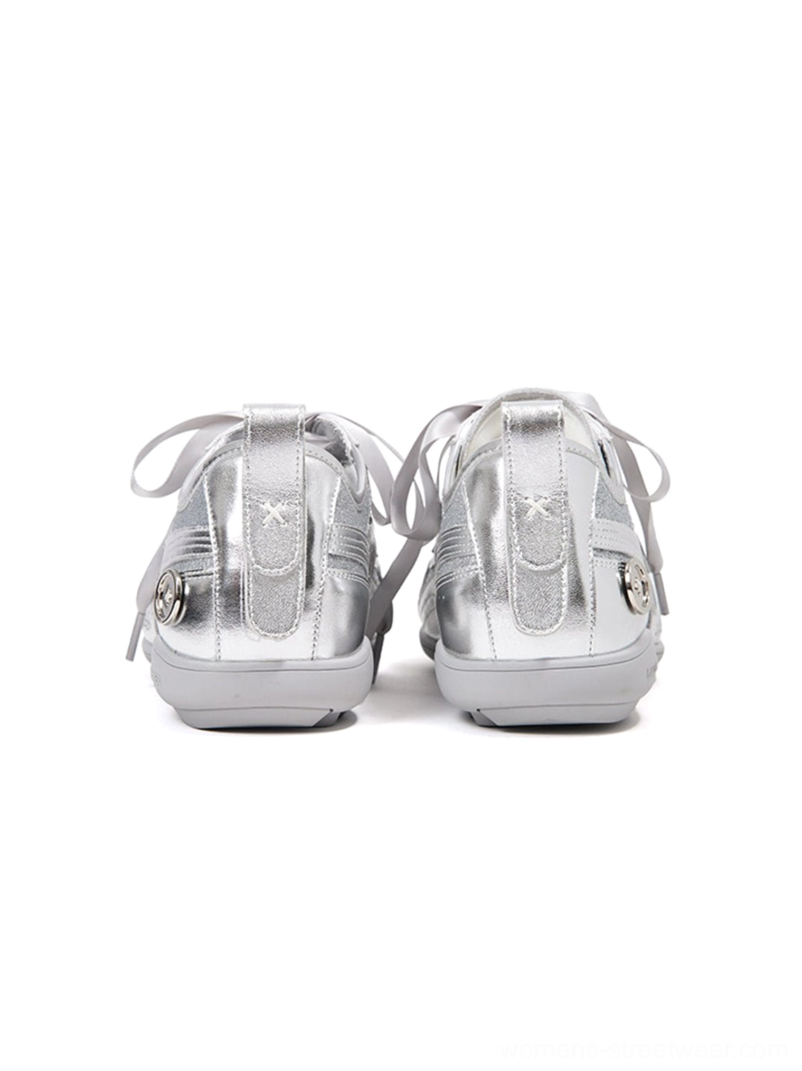 Front top-down view of silver sculpted-panel sneakers with glossy metallic toe caps and neatly tied ribbon laces
