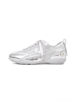 Side profile of silver sculpted-panel women's athletic trainers with metallic upper, ribbon laces, low runner sole, and futuristic streetwear design