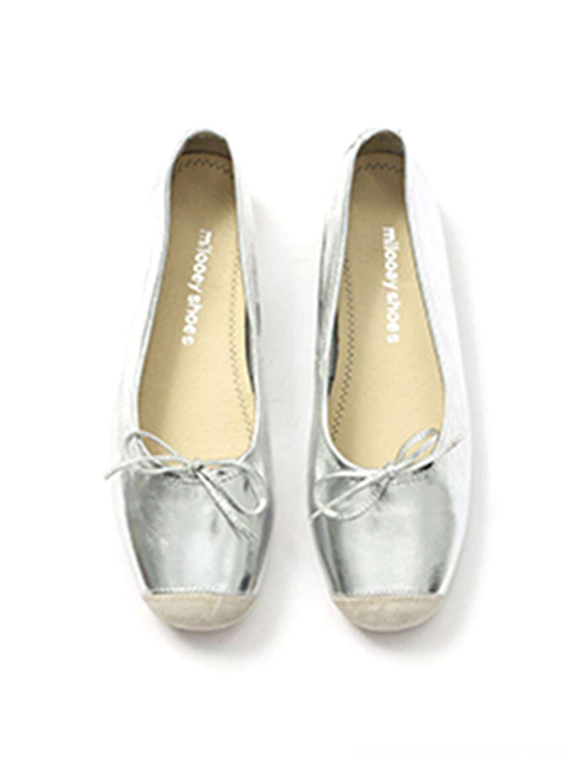 Pair of silver square-toe ballet flats showing beige toe caps, metallic uppers, and delicate bows