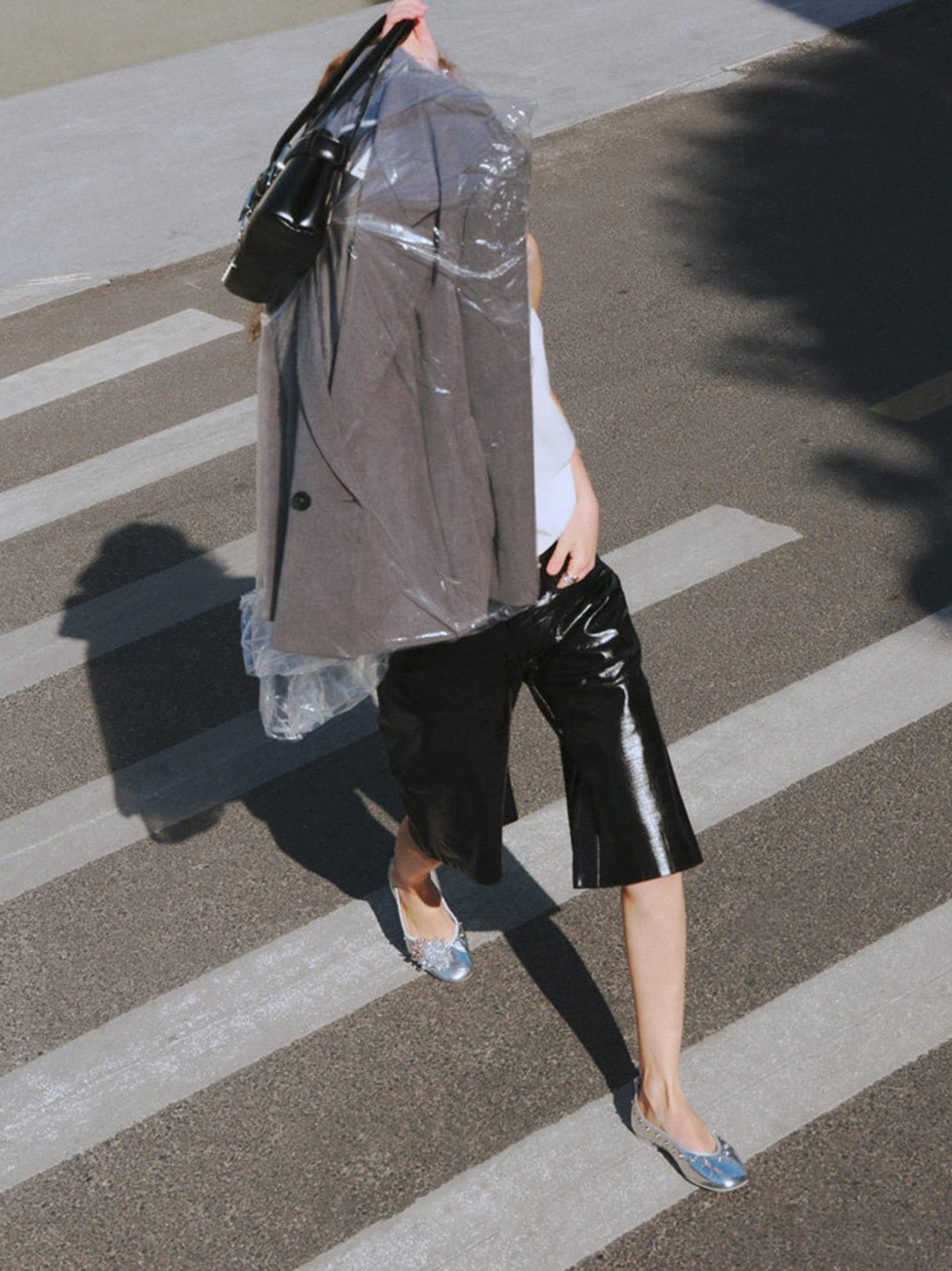 Silver square-toe studded ballet flats styled with leather shorts trench coat and black handbag