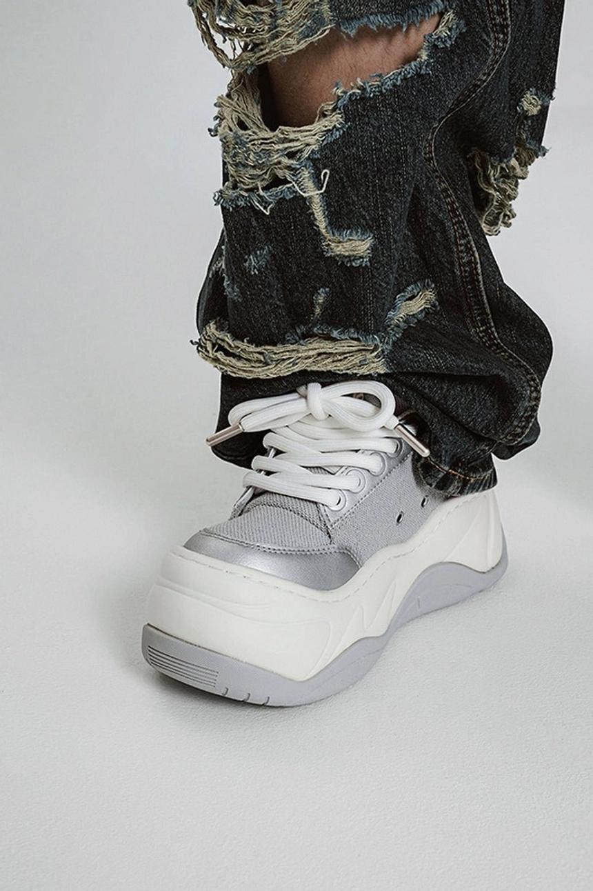 Silver metallic platform chunky sneakers styled with distressed dark wash baggy jeans