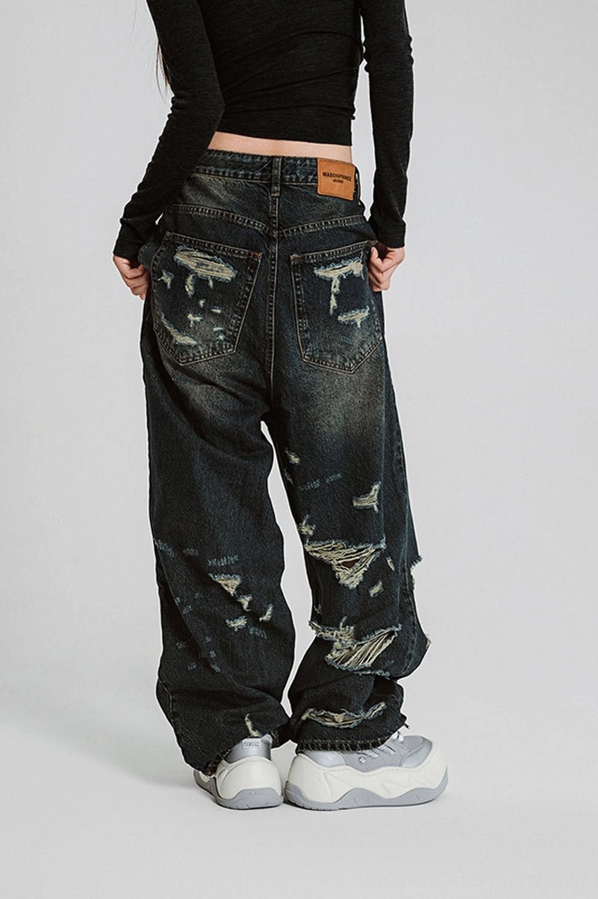 Rear outfit view of silver white chunky platform sneakers with distressed wide leg denim jeans