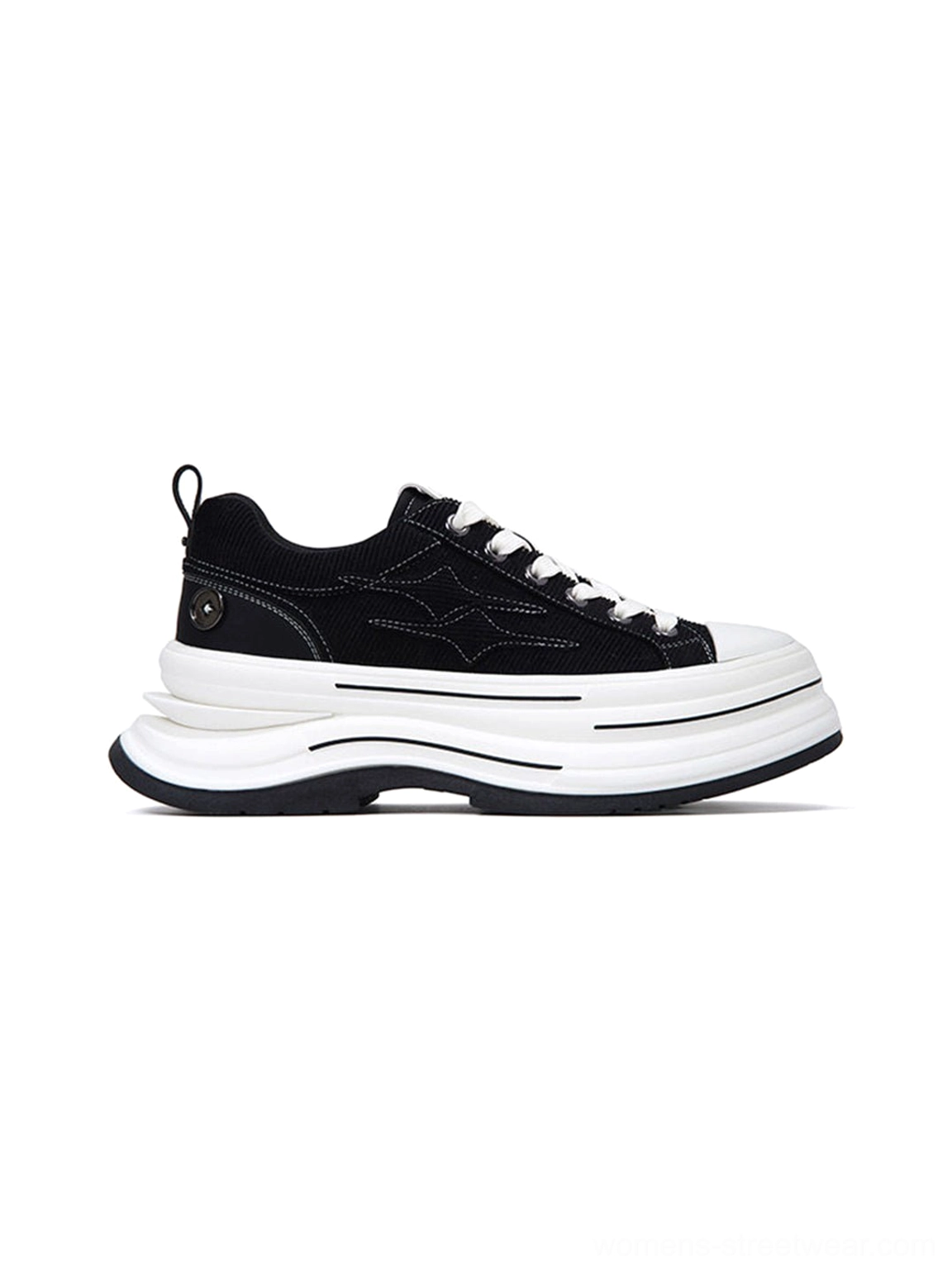 Single black 7 cm platform canvas sneaker shown from the left three-quarter angle with heel pull tab and decorative badge