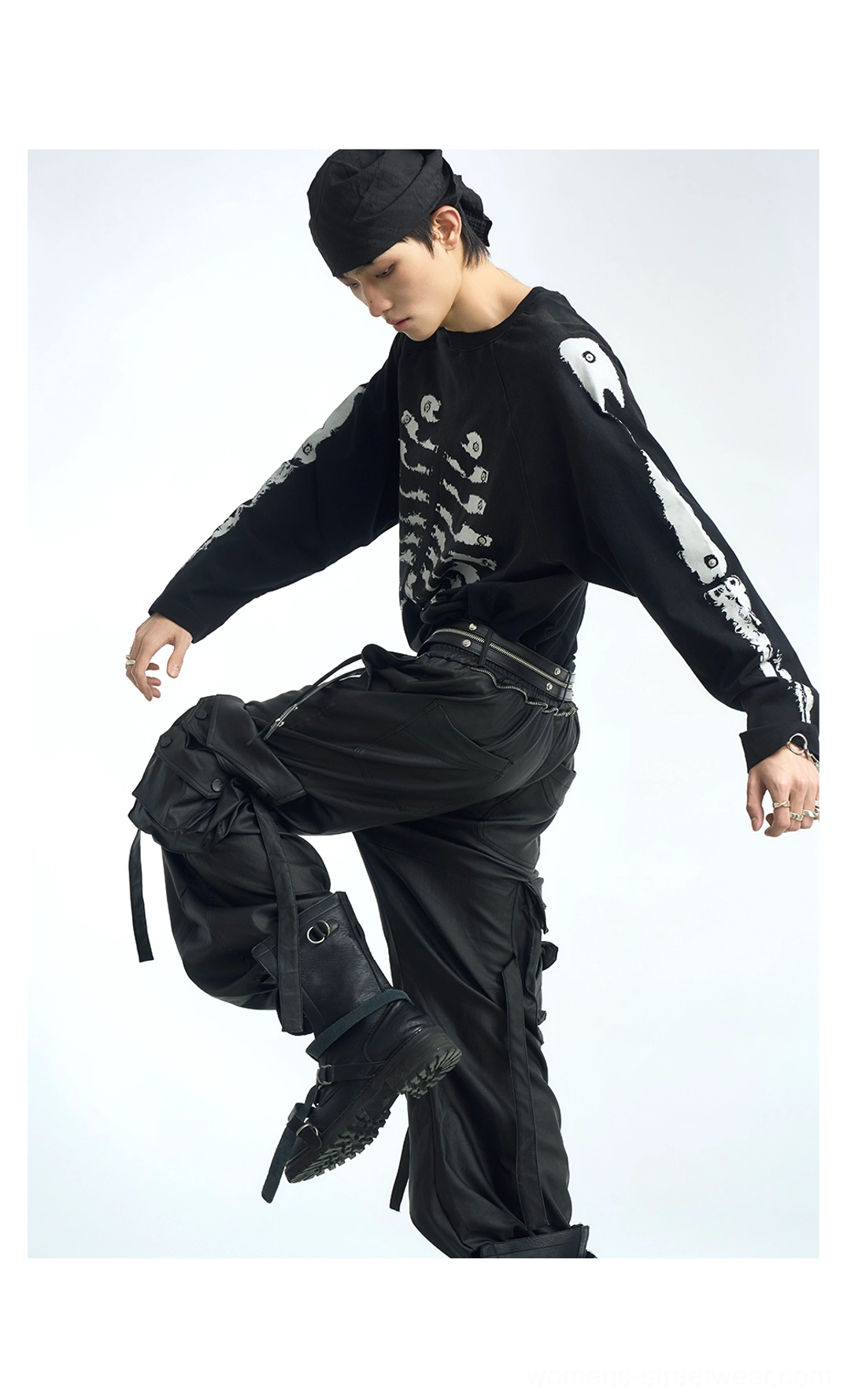 Black skeleton raglan long sleeve streetwear t-shirt styled with multi-pocket cargo pants in a dynamic full-body outfit