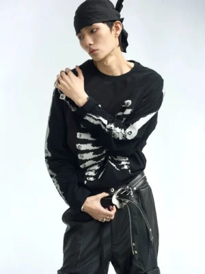 Black skeleton graphic raglan long sleeve streetwear t-shirt shown in a front half-body studio view with white ribcage and arm bone prints