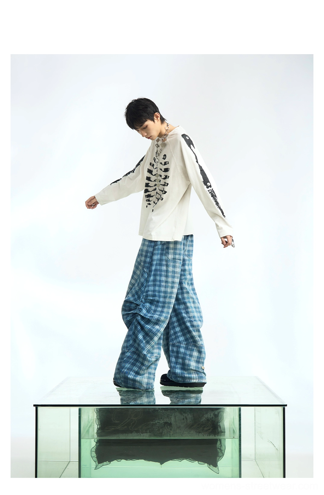 Off-white skeleton graphic raglan long sleeve streetwear t-shirt with full torso and sleeve prints styled with blue plaid wide-leg pants